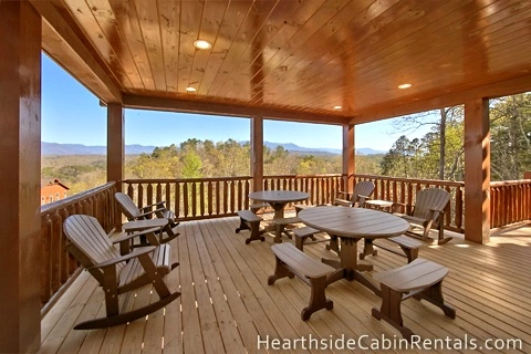  Family seating on private deck with mountain views at Pigeon Forge cabin.