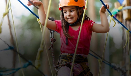 young girl on high ropes course