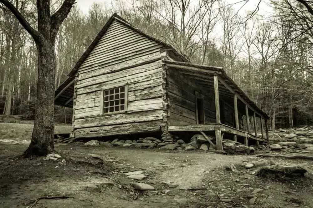 Black and white photo of a creepy cabin in the Smoky Mountains.