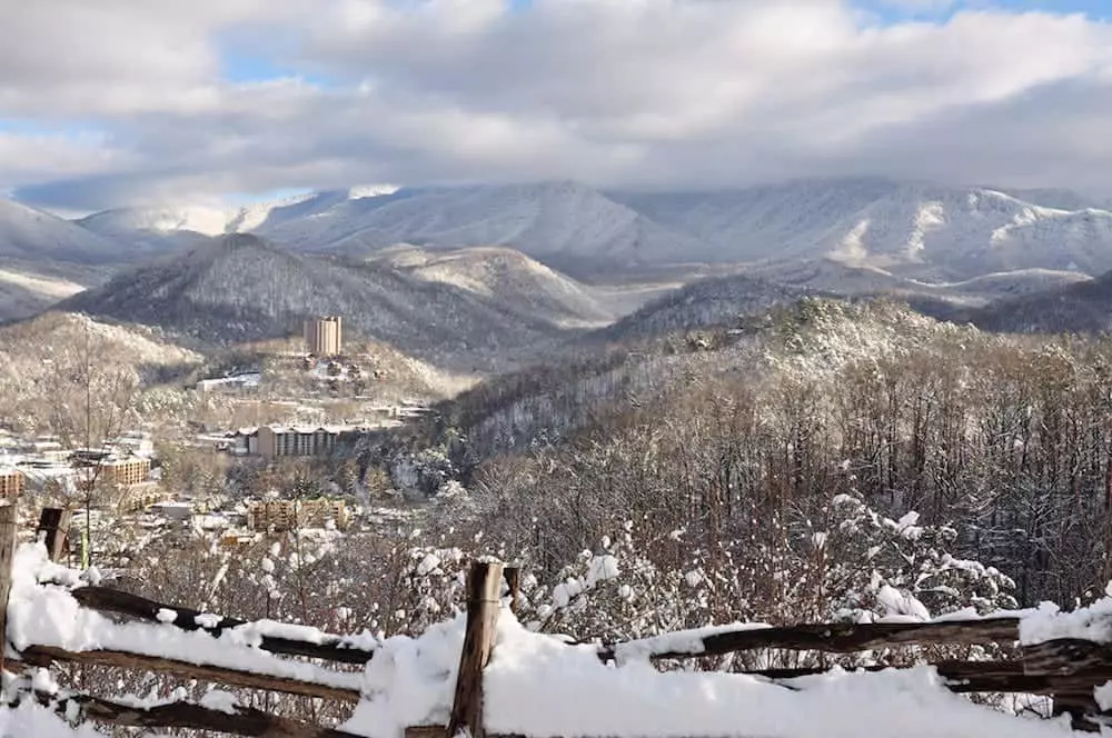 The city of Gatlinburg and the mountains covered in snow.