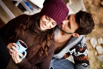 Couple cuddling at a cabin