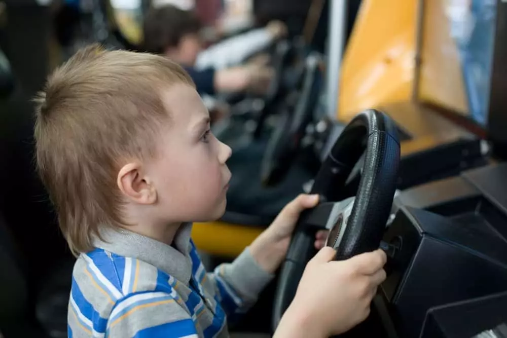 boy racing cars in Pigeon FOrge cabins with arcade games