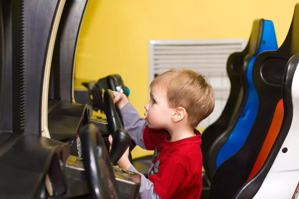 little boy staying in Pigeon Forge cabins with arcade games