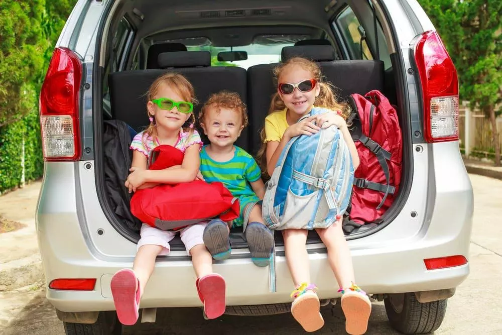 Happy family in the car on their way to our log cabin rentals in the Smoky Mountains.