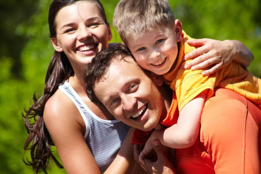 Happy family outside one of our Smoky Mountain getaway cabin rentals.