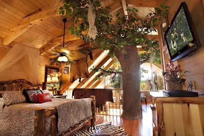 Me Tarzan You Jane cabin in Gatlinburg bedroom with tree