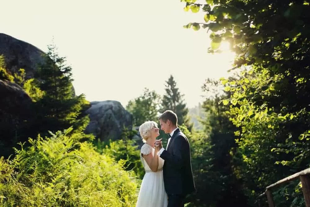 Newlyweds posing surrounded by Pigeon Forge mountains