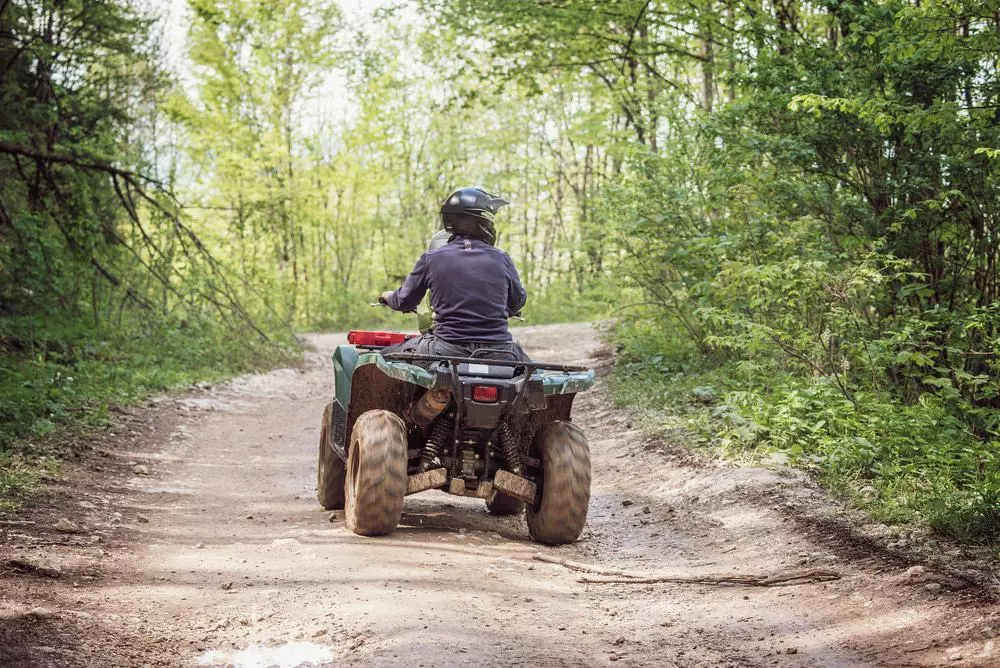 atv on a trail in the woods