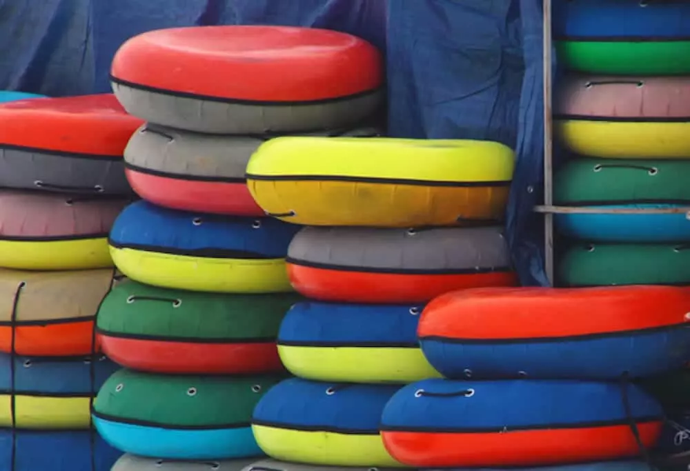 colorful inner tubes stacked against a wall