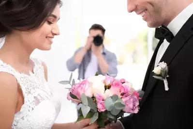 wedding photographer taking picture of couple