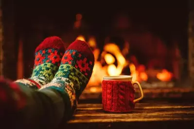 Christmas socks and hot chocolate in front of fireplace