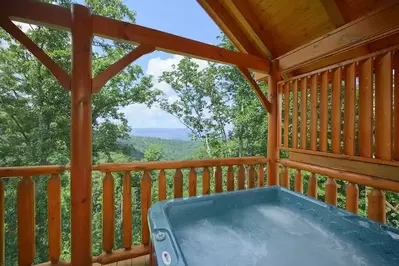 Hot tub on the deck of the High Timber Retreat cabin.
