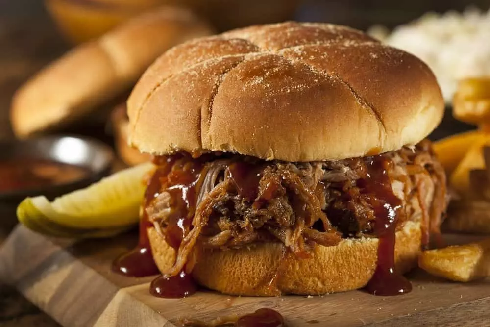 A pulled pork sandwich with BBQ sauce.