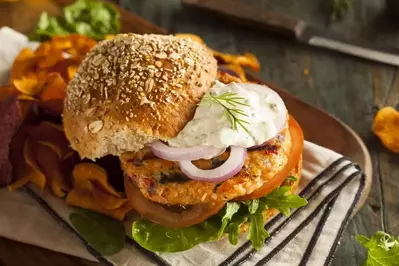 Salmon burger with tartar sauce.