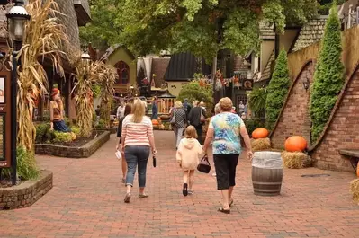 A family walking through The Village shopping area in Gatlinburg.