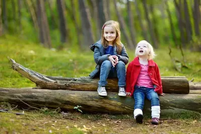 Young sisters in the woods near our Smoky Mountain luxury cabins.