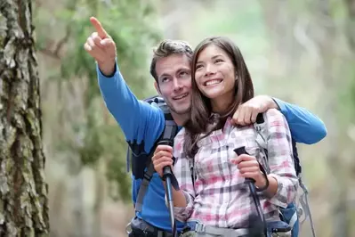 Couple hiking in the woods on their Gatlinburg honeymoon vacation.