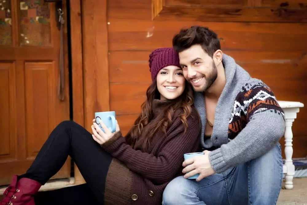couple enjoying a cup of coffee at a Smoky Mountain cabin rental.