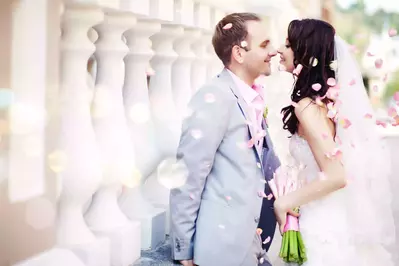 Wedding couple with pink flower petals