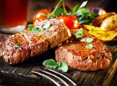 Steak, roasted tomatoes, and potatoes