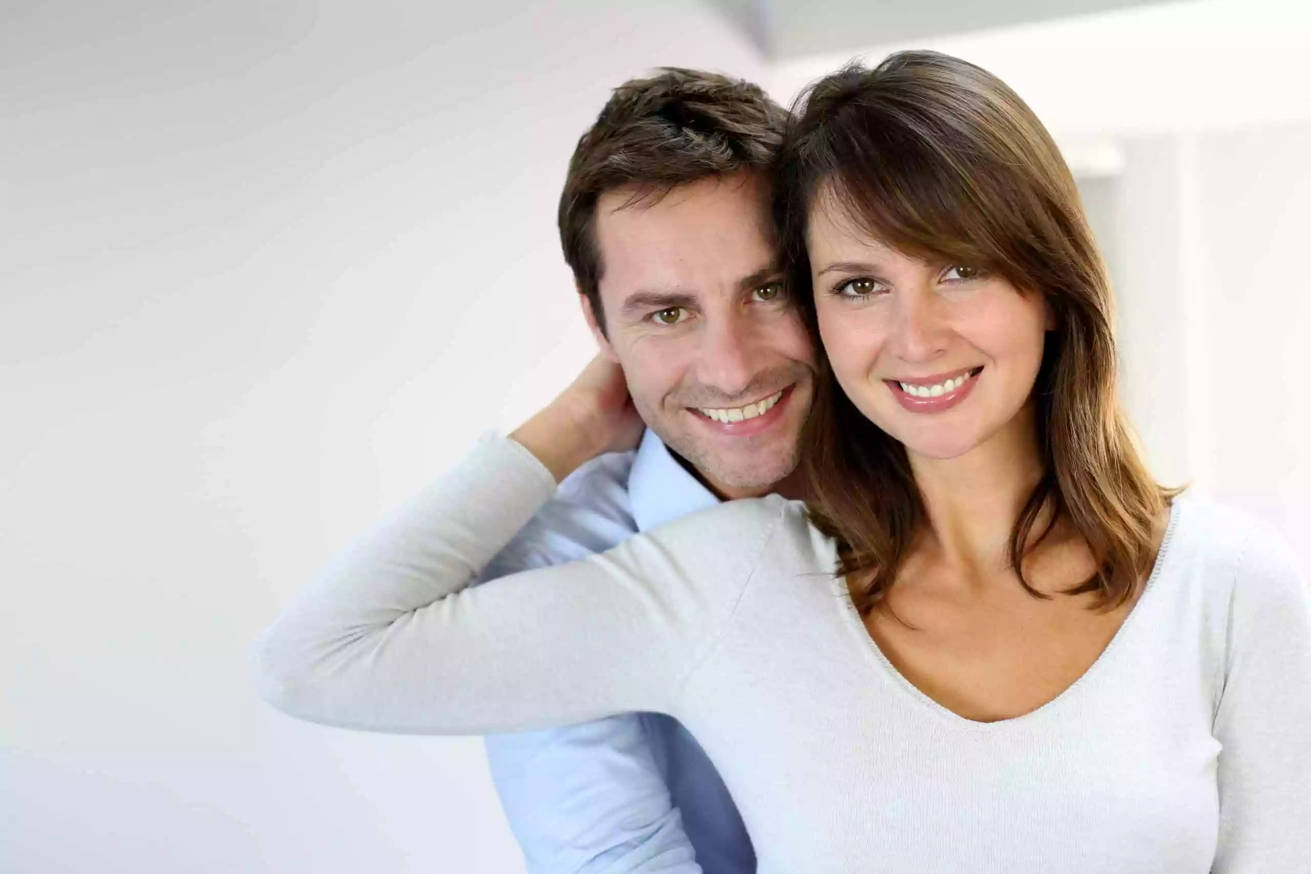 Couple in white background holding each other