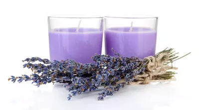 Lavender candles in front of fresh lavender