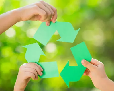 Hands holding up recycle symbol