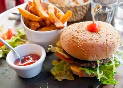 Burger, fries, and ketchup on table