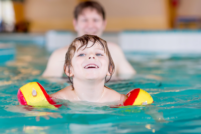 boy with floaties Pigeon Forge cabin with indoor pool