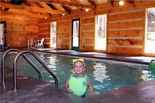 A little girl enjoying a pool in her Gatlinburg cabin.