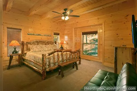 King bedroom with full-size futon at A Grand View Lodge cabin in Pigeon Forge