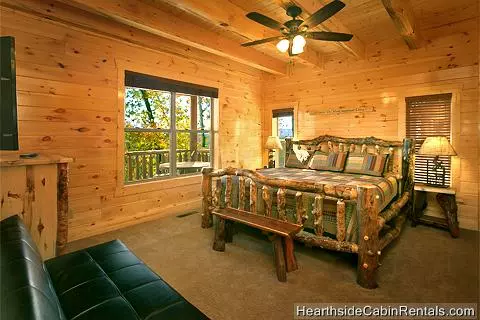  King bedroom with tv futon at A Grand View Lodge cabin in Pigeon Forge