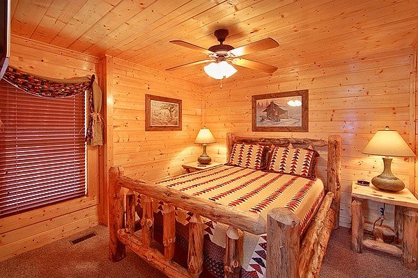 Queen size suite with tv at Heavenly Heights 8 bedroom cabin rental in Pigeon Forge