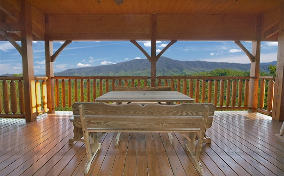 Large wooden deck with picnic table overlooking the mountains at Majestic View Lodge cabin near Pigeon Forge and Gatlinburg