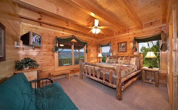 King-size bedroom with tv and full-size futon in Majestic View Lodge cabin in Pigeon Forge