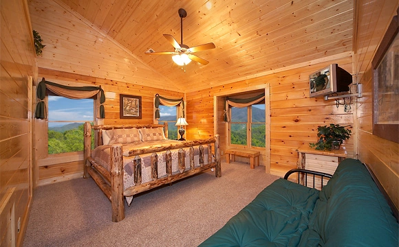King-size bedroom that overlooks the mountains with tv in Majestic View Lodge cabin in Pigeon Forge