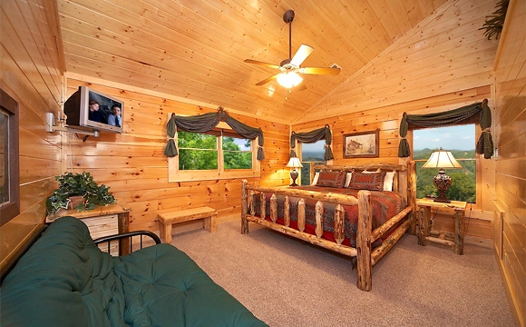 King-size bedroom with full-size futon couch in Majestic View Lodge cabin in Pigeon Forge