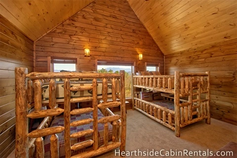 Double queen bunk beds inside Mountain Top Retreat cabin in Pigeon Forge