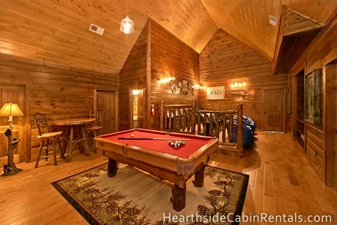 Large entertainment area inside an 8 bedroom cabin in Pigeon Forge with pool table and home theater system.