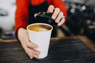 Barista with a coffee cup