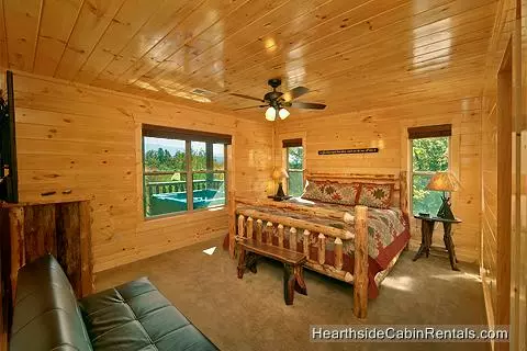  King bedroom with futon couch and tv in A View For All Seasons cabin in Gatlinburg