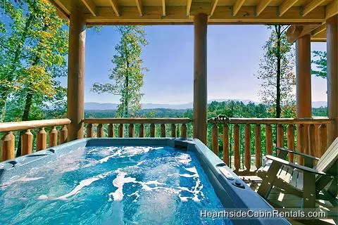 Relaxing outdoor hot tub with mountain view at cabin near Gatlinburg A View For All Seasons