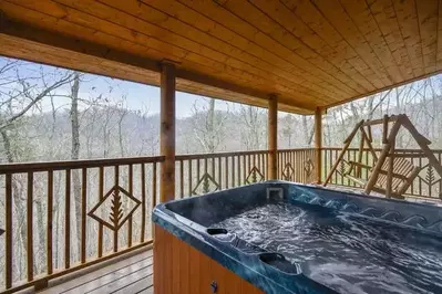Secluded Hideaway hot tub on covered deck